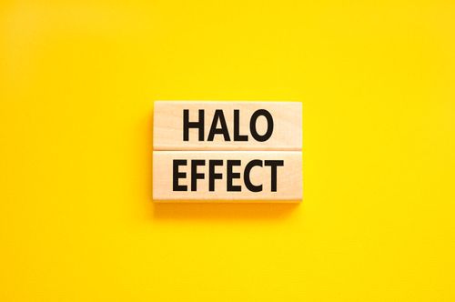 Halo effect and psychological symbol. Concept words Halo effect on beautiful wooden block. Beautiful yellow table yellow background. Business psychological and Halo effect concept. Copy space.