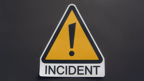 Warning sign indicating an incident on black background.