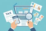 Tax payment concept.Government taxation, calculation of tax return. Man fills the tax form, documents, calendar, calculator, laptop. Pay the bills, invoices, payrolls.