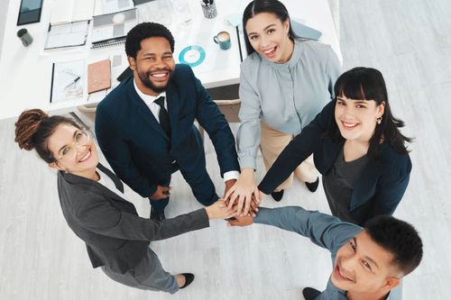 Collaboration, portrait and hands of business people in support of vision, growth and training above office. Team building, face and group unity for motivation, mission and corporate startup goal